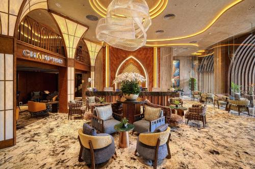 a lobby of a hotel with chairs and a large chandelier at Champton Nha Trang Hotel in Nha Trang
