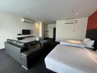 a hotel room with a bed and a couch at Estella Hotel in Pelabohan Klang