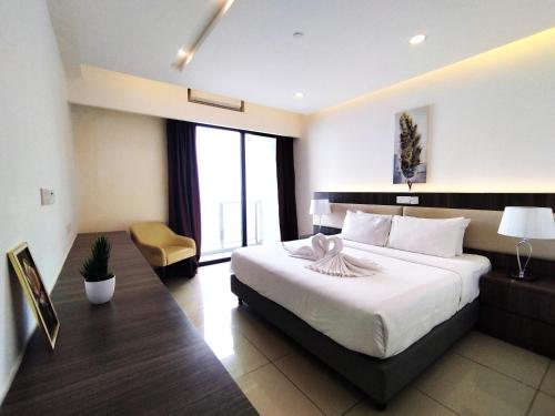 a hotel room with a large bed and a chair at Genting SmokyColdInn1R1B AT Ion Delemen in Genting Highlands