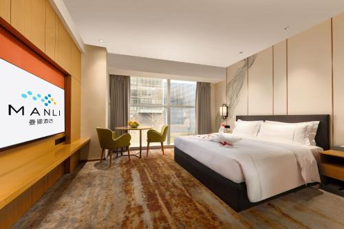 Ένα ή περισσότερα κρεβάτια σε δωμάτιο στο 南山海岸城曼骊酒店