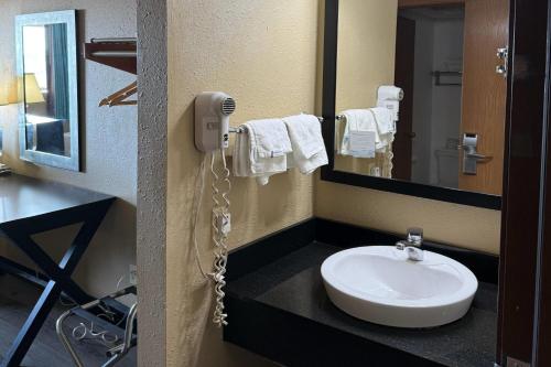 a bathroom with a sink and a phone on the wall at Super 8 by Wyndham Mendota I-39 in Mendota