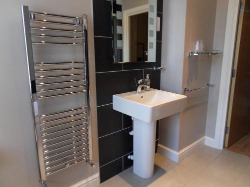 a bathroom with a sink and a mirror at Croft Guesthouse in Cockermouth