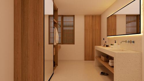 a bathroom with a sink and a mirror at Bvilla Spa in Seminyak