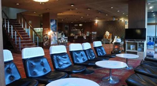 a waiting area with chairs and tables in a store at Inuyamakan in Inuyama