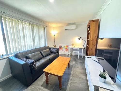 a living room with a couch and a table at Midvale Cozy House in Bellevue