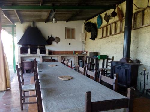 a large dining room with a long table and chairs at Alojamiento Rural Manantial de los Cañitos in El Bosque