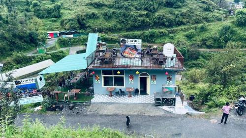 an aerial view of a house on a hill at River Side Gorilla Resort Mussoorie in Mussoorie