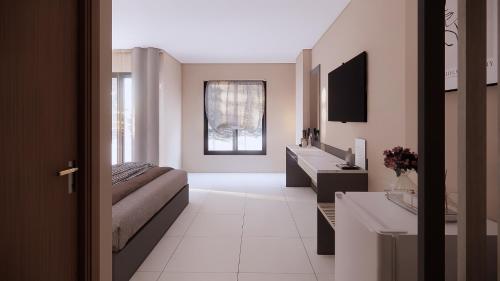 a living room with a couch and a television at Prajan Residence in Buriram