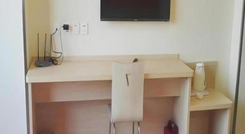 a white desk with a television on top of it at 7 Days Inn Dongsheng Railway Station in Zhaoyoufang
