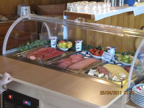 a buffet with different types of food on a counter at Wäldebauernhof in Gutach