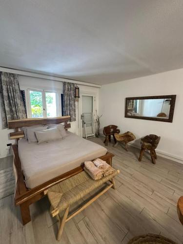 a bedroom with a large bed in a room at Studio avec jardin et piscine in Saint-François