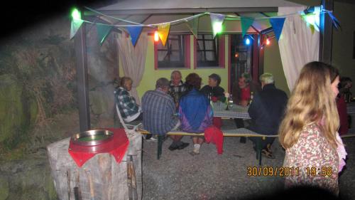 a group of people sitting in a room with lights at Wäldebauernhof in Gutach