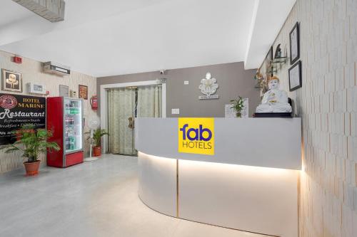 a fotohens sign on a counter in a room at FabHotel Marine - Vishnu Temple Bada Lalpur in Varanasi
