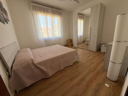 a bedroom with a bed and a large window at Casa del Mare in Marotta