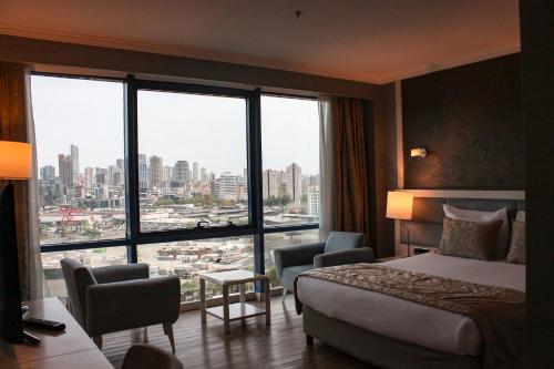a hotel room with a bed and a large window at Byotell Istanbul in Istanbul