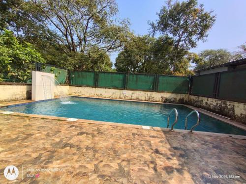 two white swans standing in a swimming pool at Vista Vagator Junction by Dia Hotels and Homes in Anjuna