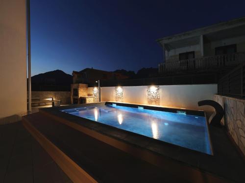 a swimming pool on top of a building at night at Villa with Heated Pool in Seline
