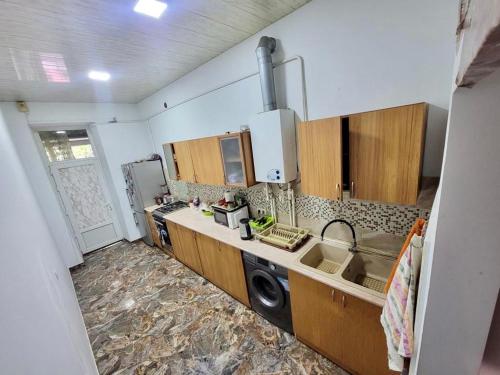 a kitchen with a sink and a microwave at KAR & SON guesthouse in Yerevan