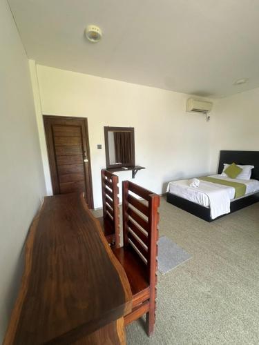 Postel nebo postele na pokoji v ubytování OrientalResort Kekirawa