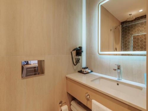 a bathroom with a sink and a mirror at Echinus Blue Hotel in Antalya