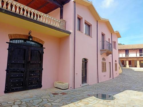 a building with a black door on the side of a street at Il Borgo in Iglesias
