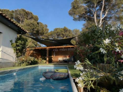 a swimming pool in the yard of a house at Villa Le M in Six-Fours-les-Plages