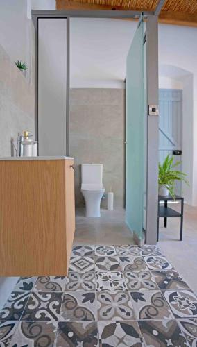 a bathroom with a sink and a toilet in a room at stonebuilt HiddenHouse in Paphos