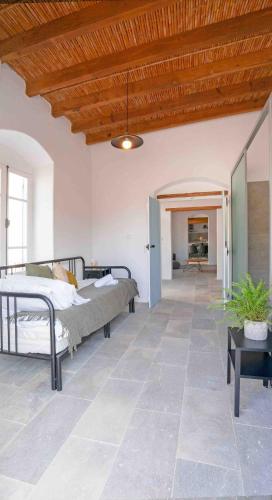a bedroom with two beds and a wooden ceiling at stonebuilt HiddenHouse in Paphos