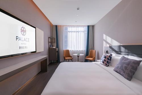 a hotel room with a bed and a flat screen tv at Langliz Hotel Capital Airport New International Exhibition Center Branch in Beijing