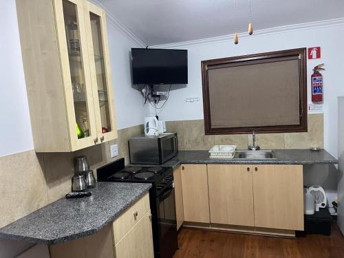 a small kitchen with a sink and a stove at 7 on Bellevue in White River