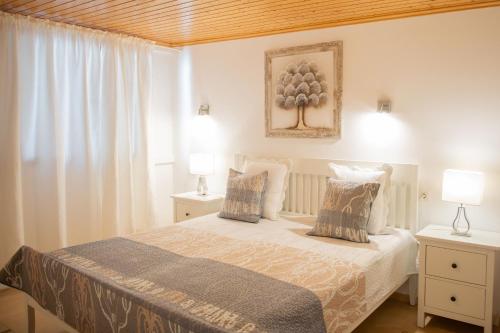 a bedroom with a bed with two night stands and two lamps at Villa Sol in Charco del Palo