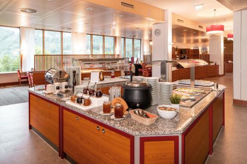 a kitchen with a counter with food on it at Vivea Hotel Bad Goisern in Bad Goisern