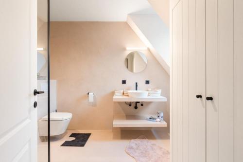 a bathroom with a sink and a toilet at exceptional luxury villa near Knokke Golf in Knokke-Heist