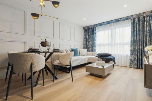a living room with a couch and a table at 2BR West End Apartment Near Botanic Gardens in Glasgow