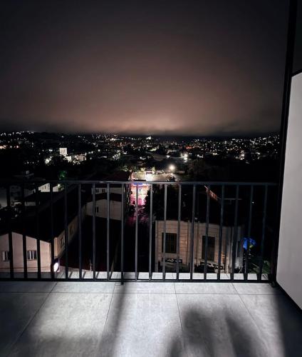 a view of a city at night from a balcony at Apartment mountine viev in Kutaisi