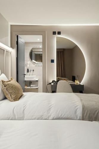 a bedroom with a white bed with a desk and a mirror at 2BR West End Apartment Near Botanic Gardens in Glasgow