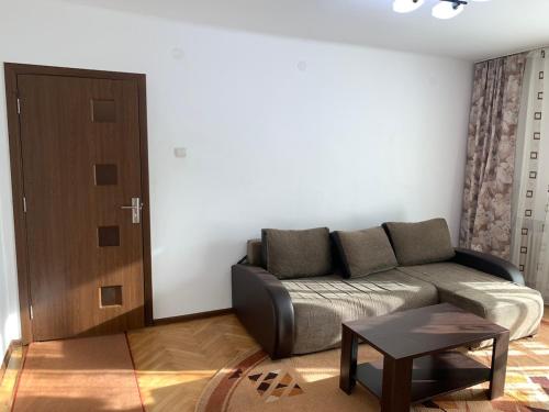 a living room with a couch and a table at Old Center Apartment in Craiova