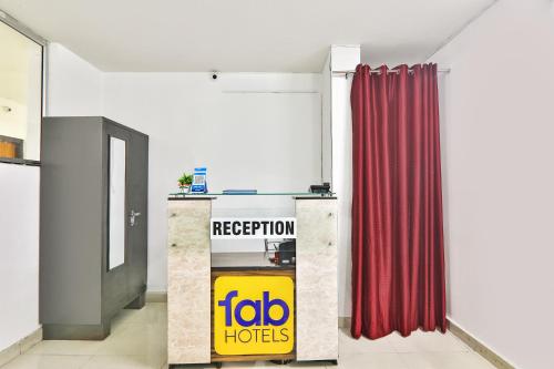 a red curtain in a room with a fico hotel sign at FabHotel Raas Inn in Lucknow