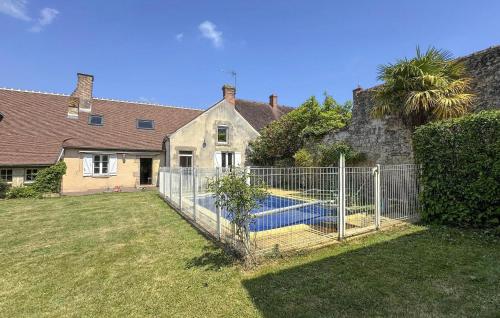 a fence in front of a house with a swimming pool at Cozy Home In Ingrannes With Private Swimming Pool, Can Be Inside Or Outside in Ingrannes