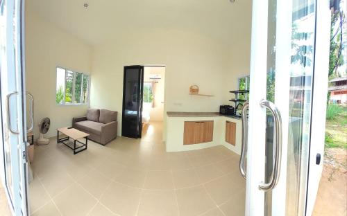 a living room with a couch and a table at Houses in Ban Nua