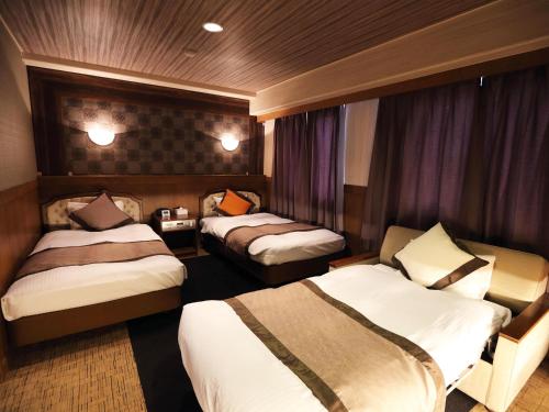 Postel nebo postele na pokoji v ubytování Hotel Areaone Kochi