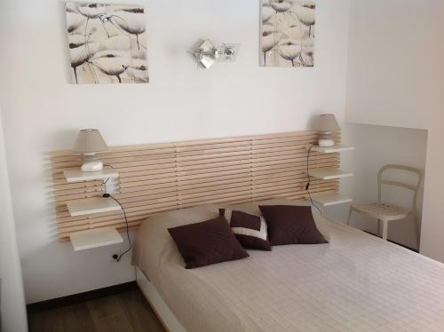 a bedroom with a bed and two pictures on the wall at Gite Le Cros De Céor in Cassagnes-Bégonhès