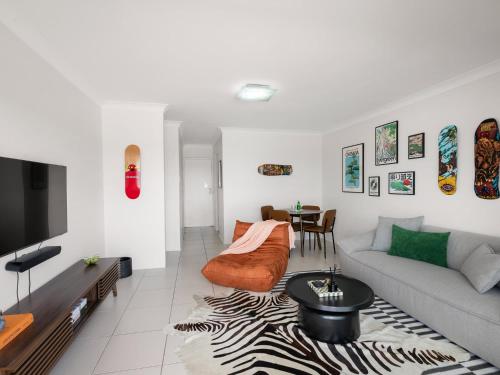 a living room with a couch and a table at Pine Street Apartments Bulimba in Brisbane