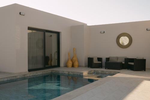 a living room with a swimming pool in the middle of a building at Unlimited Terra Villas, Charming Nature Escapes, By ThinkVilla in Hersonissos