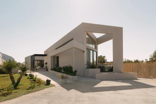 a large white house with a driveway at Unlimited Terra Villas, Charming Nature Escapes, By ThinkVilla in Hersonissos