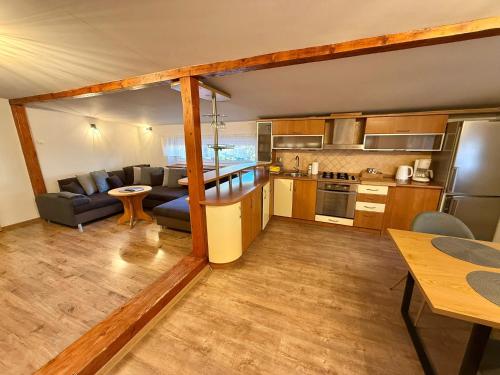 eine Küche und ein Wohnzimmer mit einer Couch und einem Tisch in der Unterkunft Apartament Na Górskiej in Szczyrk