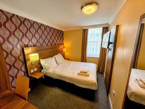 Ένα ή περισσότερα κρεβάτια σε δωμάτιο στο City Continental London Kensington