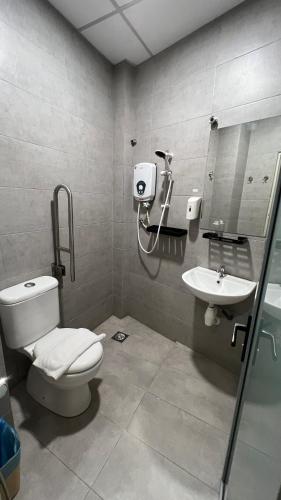 a bathroom with a toilet and a sink at Cojoy Hotel @ Chinatown in Kuala Lumpur