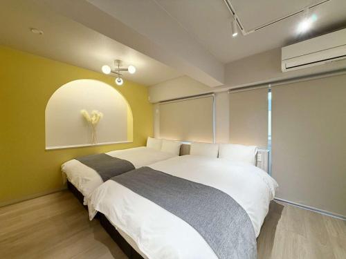 une chambre avec deux lits et une fenêtre dans l'établissement Clio Matoba by b hotel - Fully Equipped Urban Studio Peaceful Stay, à Ōsukachō