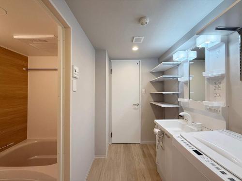 a bathroom with a sink and a toilet and a tub at Clio Matoba by b hotel - Fully Equipped Urban Studio Peaceful Stay in Ōsukachō